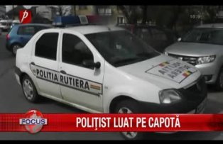 Poliţist luat pe capotă