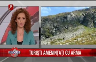 Turisti amenintati cu arma